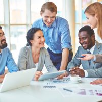 Group of business partners discussing strategies at meeting in office